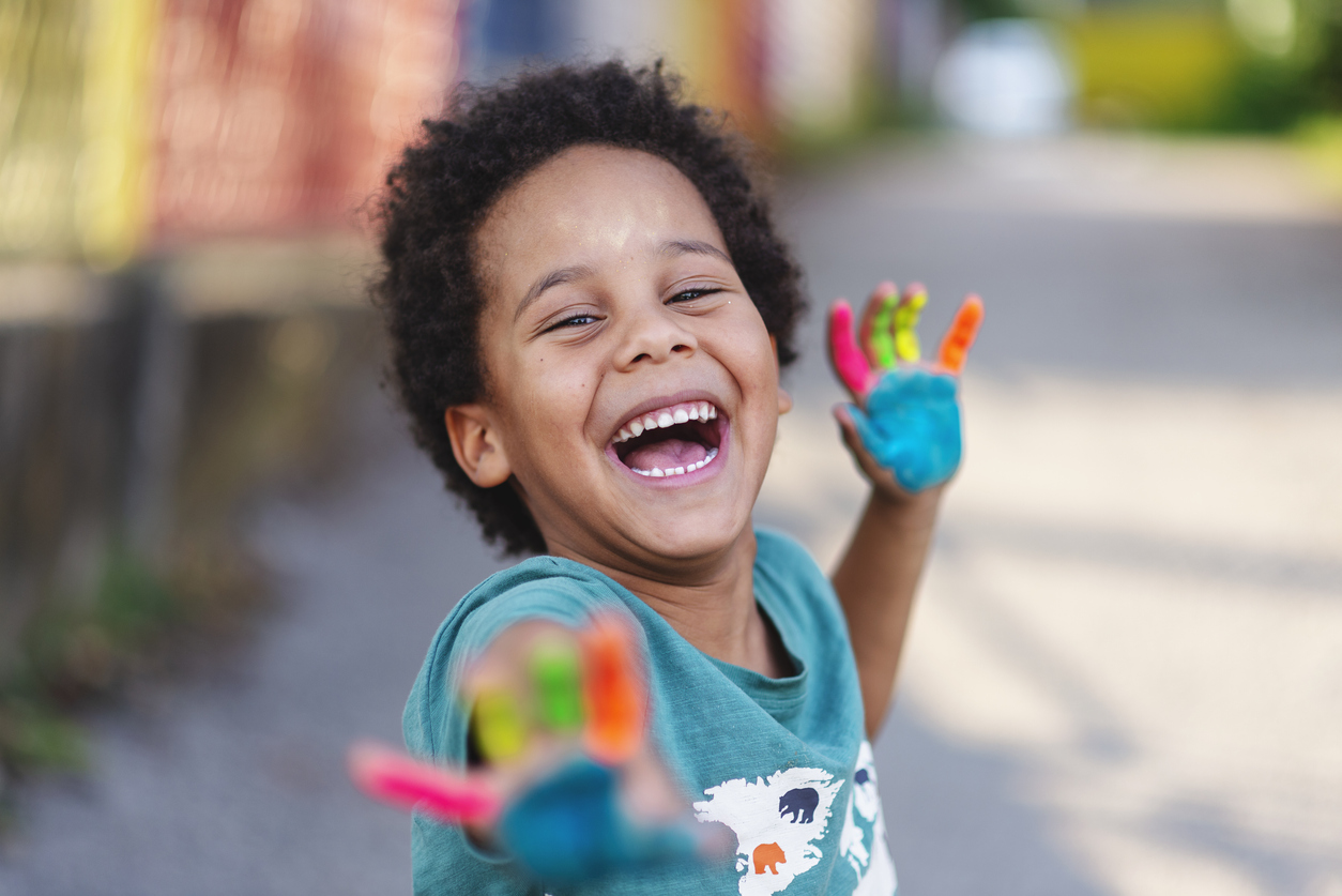 happy boy with painted hands